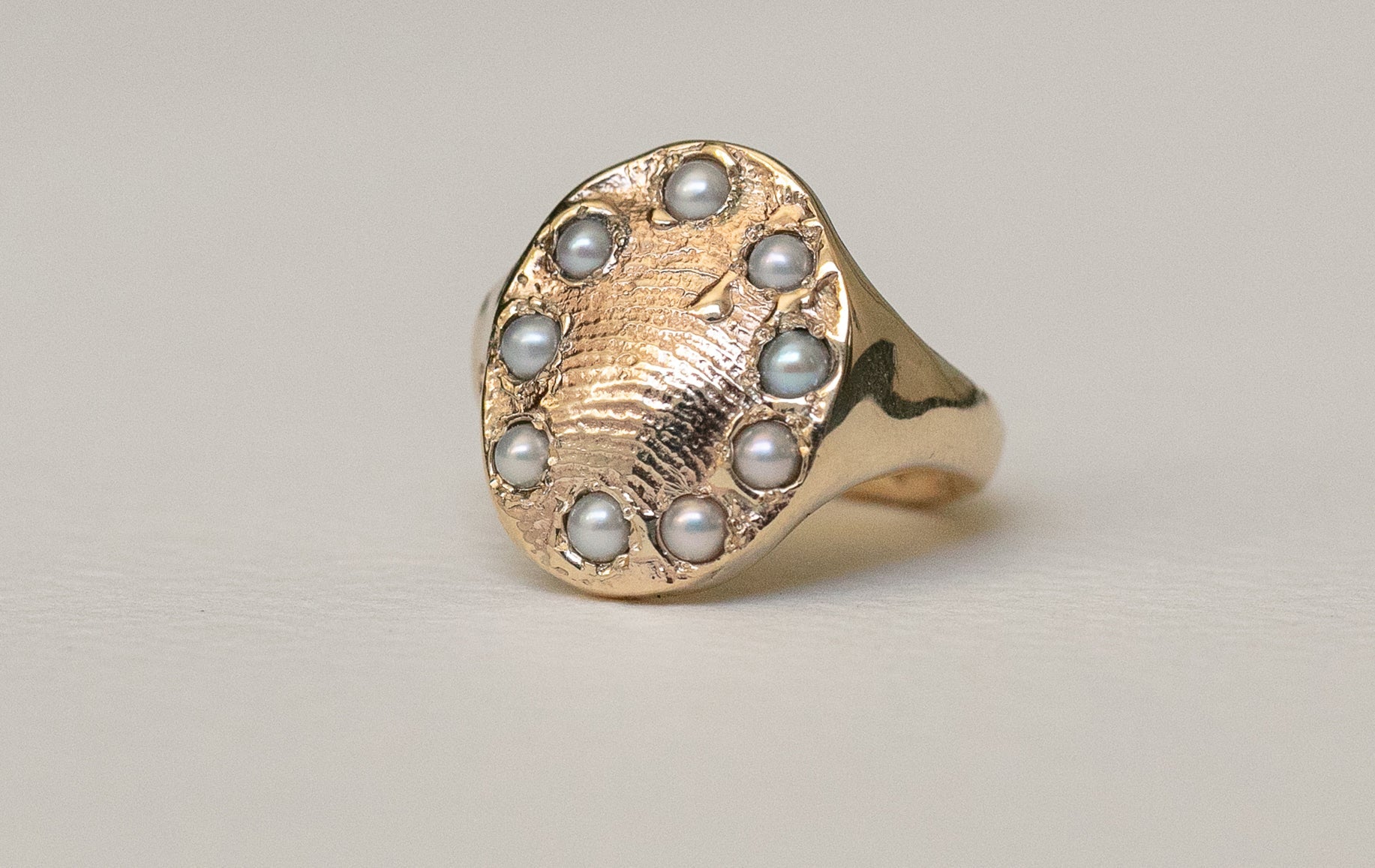 A Mourning Jewelry Ring crafted in 18ct solid yellow gold, featuring a textured organic design with intricate pearls set into the metal around the fingerprint, symbolizing love and remembrance.